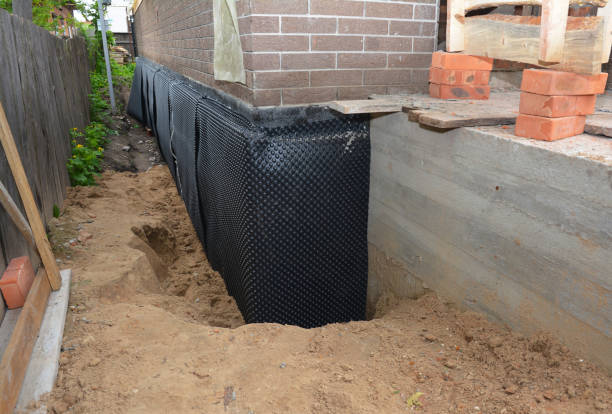 Happy homeowners after waterproofing job in Adger